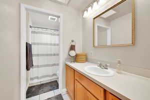 Bathroom featuring tile patterned flooring, vanity, and toilet