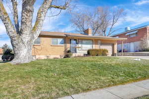 Ranch-style house featuring a front lawn