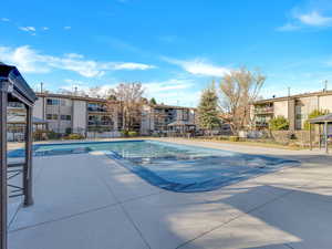 View of swimming pool with a patio