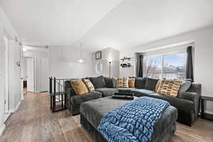 Living room featuring hardwood / wood-style floors and lofted ceiling