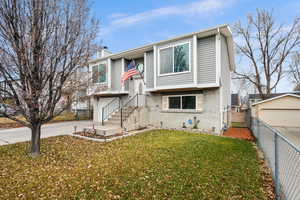 Raised ranch with a front yard and a garage