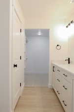 Bathroom featuring vanity and wood-type flooring