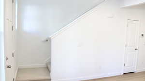 Stairway featuring hardwood / wood-style floors