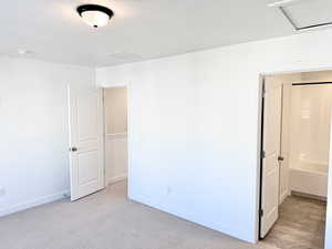 Empty room featuring light carpet