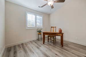 Office area with ceiling fan and light hardwood / wood-style floors