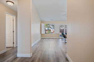 Corridor featuring light wood-type flooring