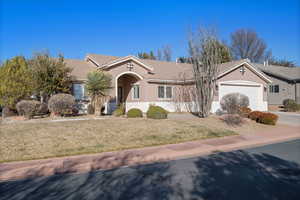 Ranch-style home with a garage and a front lawn