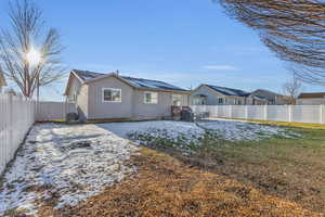 Rear view of house featuring a yard