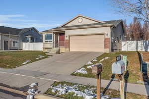 Ranch-style house with a front yard and a garage