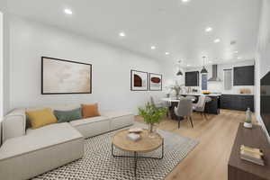 Living area with recessed lighting and light wood-style floors