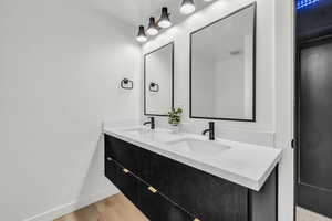 Bathroom featuring vanity and wood-type flooring