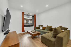 Living room with light hardwood / wood-style flooring