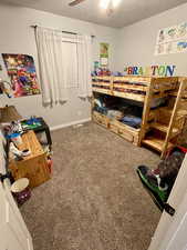 Carpeted bedroom with a textured ceiling