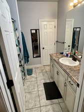 Master bathroom with tile patterned flooring and vanity