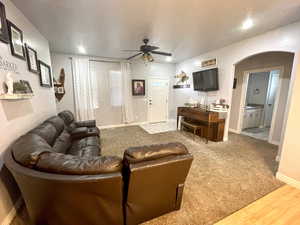 Living room featuring wood-type flooring and ceiling fan