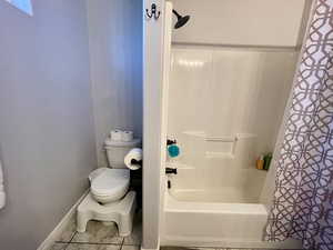 Bathroom featuring tile patterned flooring and toilet