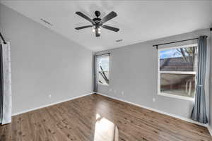 Unfurnished room with ceiling fan, wood-type flooring, and lofted ceiling