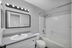 Full bathroom with vanity, toilet, and shower / washtub combination