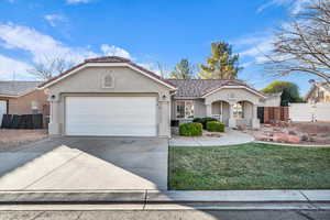 View of front facade featuring a garage and a front yard