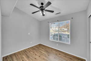 Empty room featuring wood-type flooring and ceiling fan