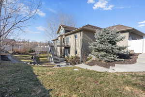 View of fully landscaped back yard with mature trees.