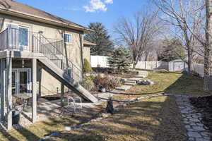 View of yard featuring a shed and the upstairs and downstairs patios.