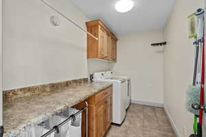 Laundry area with tile floors, built-in counter and cabinets. This washer and dryer are NOT included.