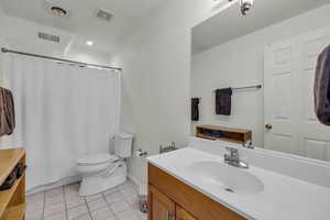 Bathroom featuring tile patterned flooring, vanity, and toilet