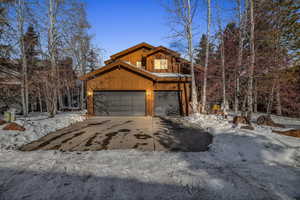 View of snow covered exterior featuring a garage