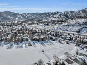 Snowy aerial view featuring a mountain view