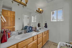 Bathroom featuring tile patterned flooring and vanity