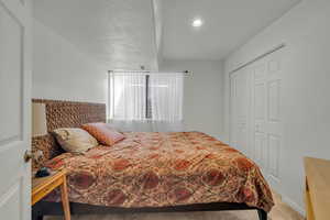 Bedroom featuring carpet floors and a closet