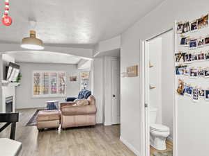 Living room with a textured ceiling and light wood-type flooring