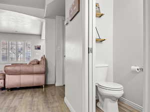 Bathroom with hardwood / wood-style flooring and toilet