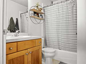 Bathroom featuring tile patterned flooring, vanity, and toilet