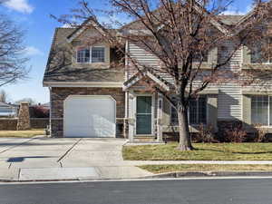 View of front of house featuring a garage and a front yard