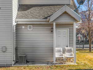 Exterior space featuring cooling unit and a lawn