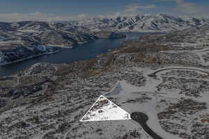 Drone / aerial view featuring a water and mountain view