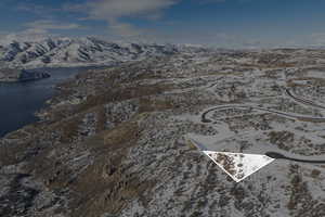 Snowy aerial view with a water and mountain view