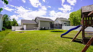 View of yard with a playground, a patio, and a trampoline