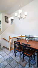 Dining space with an inviting chandelier and lofted ceiling