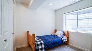 Carpeted bedroom featuring a textured ceiling