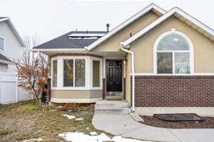 Doorway to property featuring solar panels and  new double pane windows