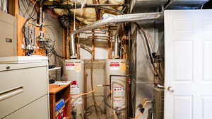 Utility room featuring TWO water heaters