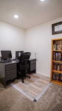 Carpeted office with a textured ceiling