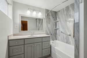 Bathroom with vanity and washtub / shower combination