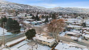 Snowy aerial view featuring a mountain view