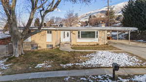 Ranch-style home with a mountain view and a carport