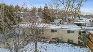 Snow covered property with cooling unit