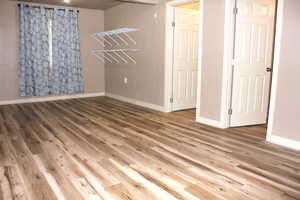 Basement Bedroom (#6) with large walk-in closet and wood-style floors